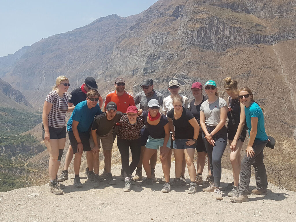 3 DAY COLCA CANYON TREK: A breathtaking view of an adventurer trekking through the stunning Colca Canyon over three days, surrounded by dramatic landscapes, deep ravines, and the winding Colca River, offering an unforgettable journey through one of Peru's most iconic natural wonders."